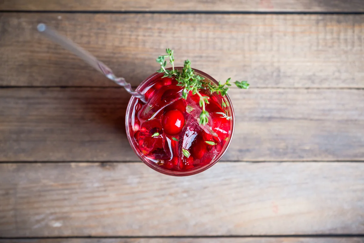 Christmas cocktail with berries and thyme