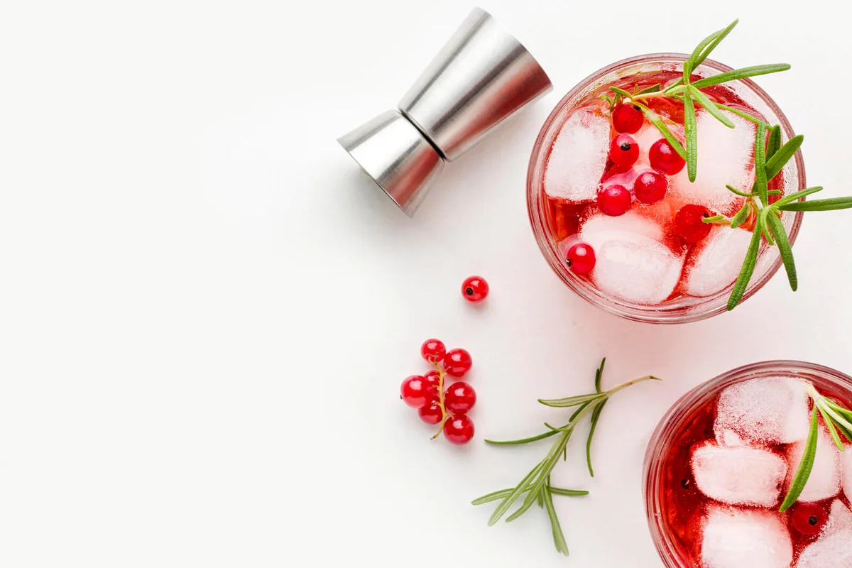Top view cranberry vodka glasses with ice copy space