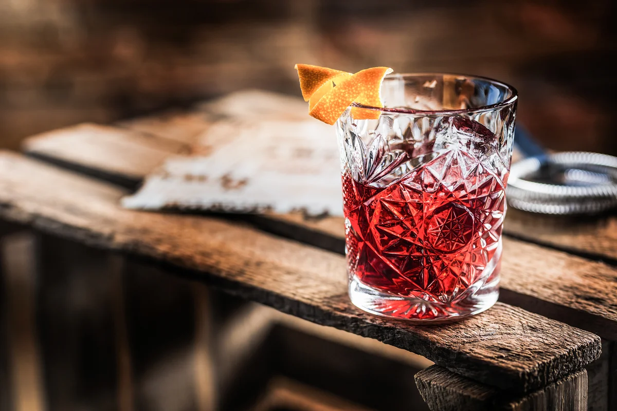 Cocktail Negroni on a old wooden board