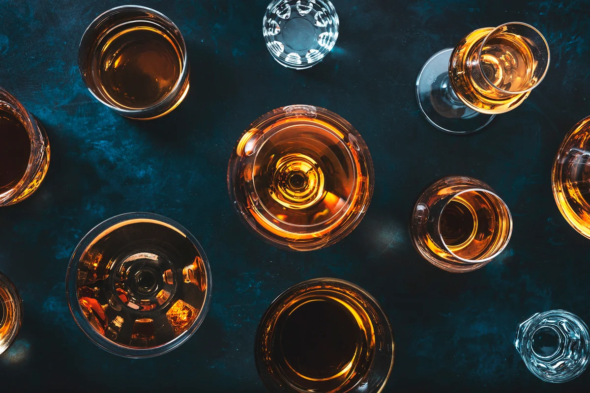 trong alcohol drinks, blue background, top view