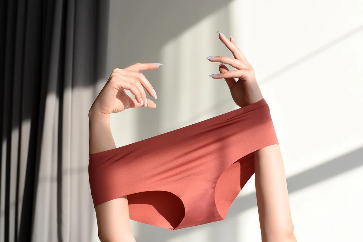 Seamless female panties in the hands of the girl