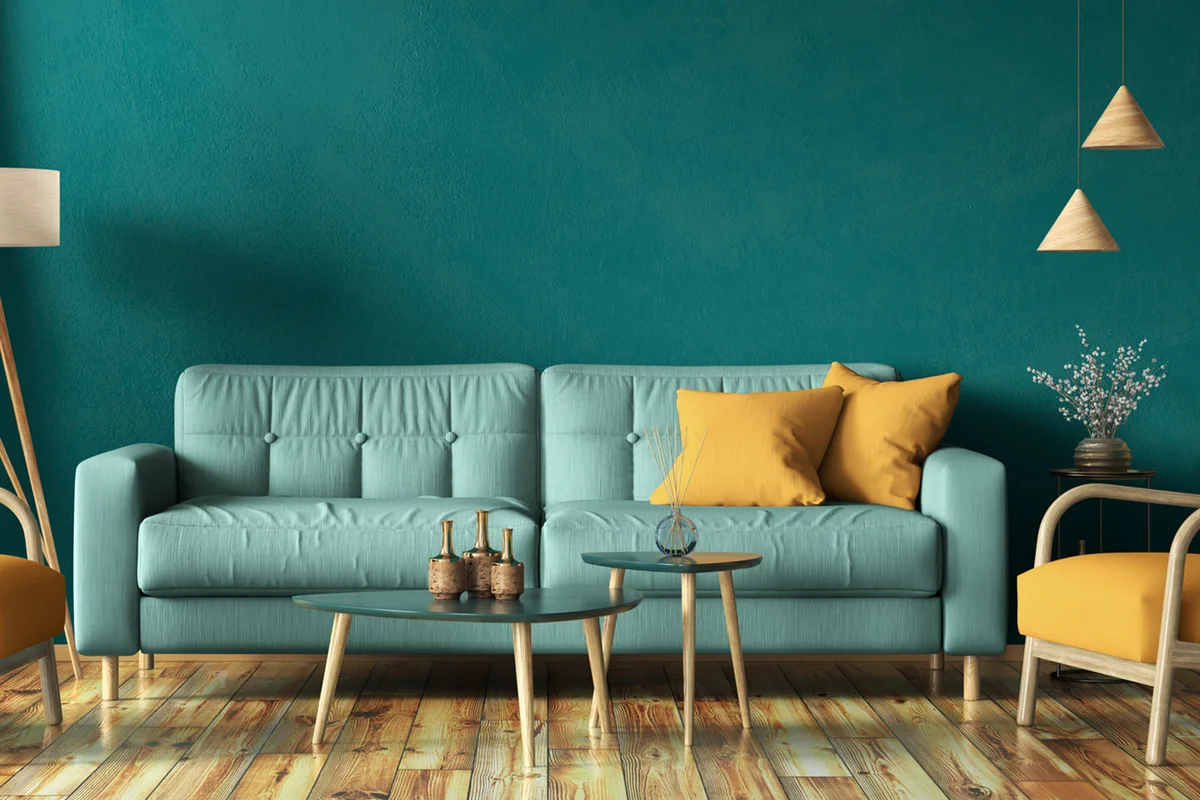 Turquoise sofa against teal living room wall