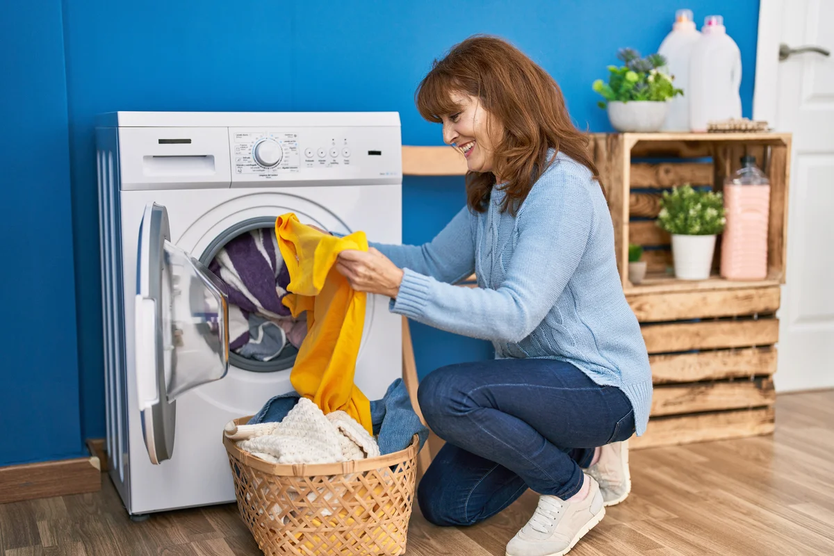 Woman doing laundry in blue room