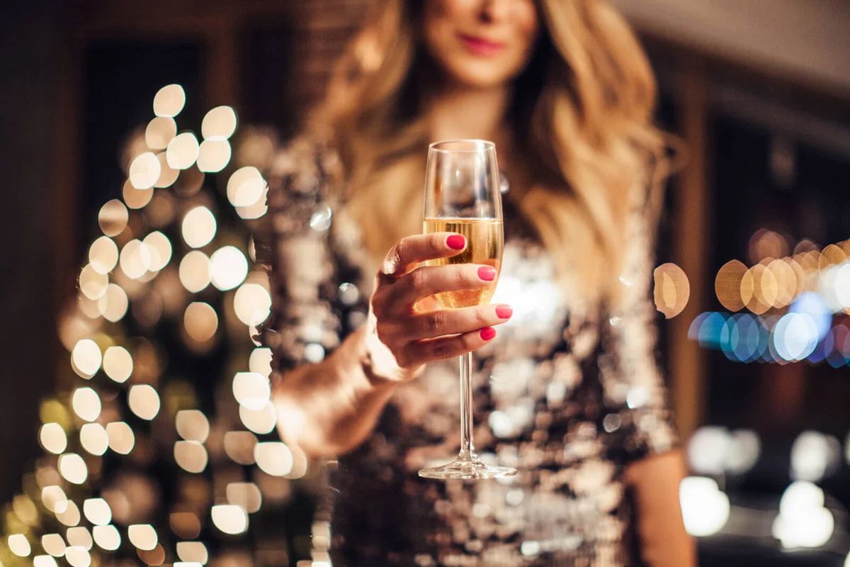 woman's heands holding glass of champagne