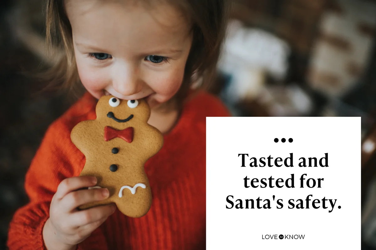 Cute little girl biting gingerbread man