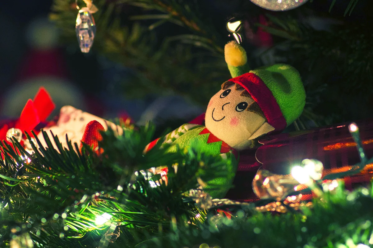 An elf is "mischievously" found lounging around on the family Christmas Tree