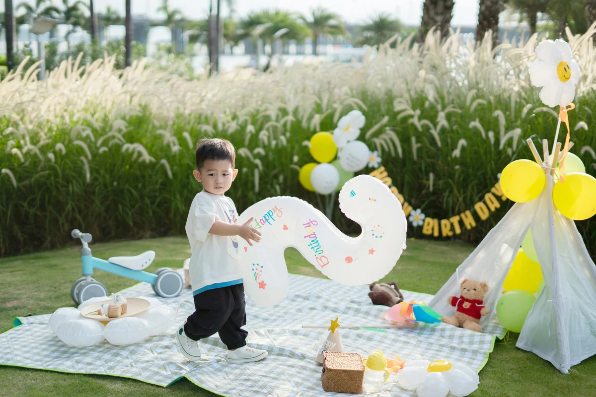 Little boy having birthday party with a tent