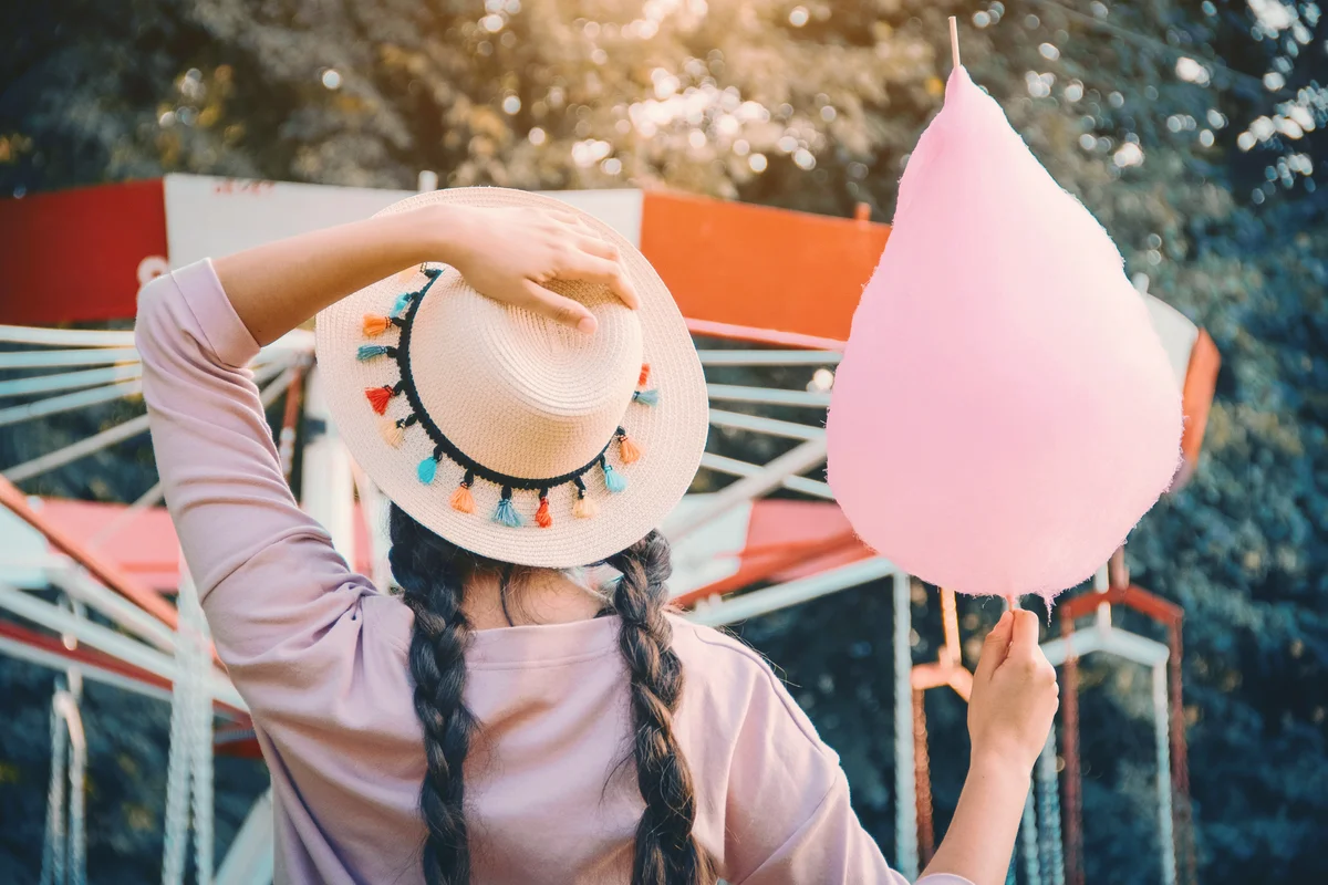 Girl with cotton candy at carnival birthday party