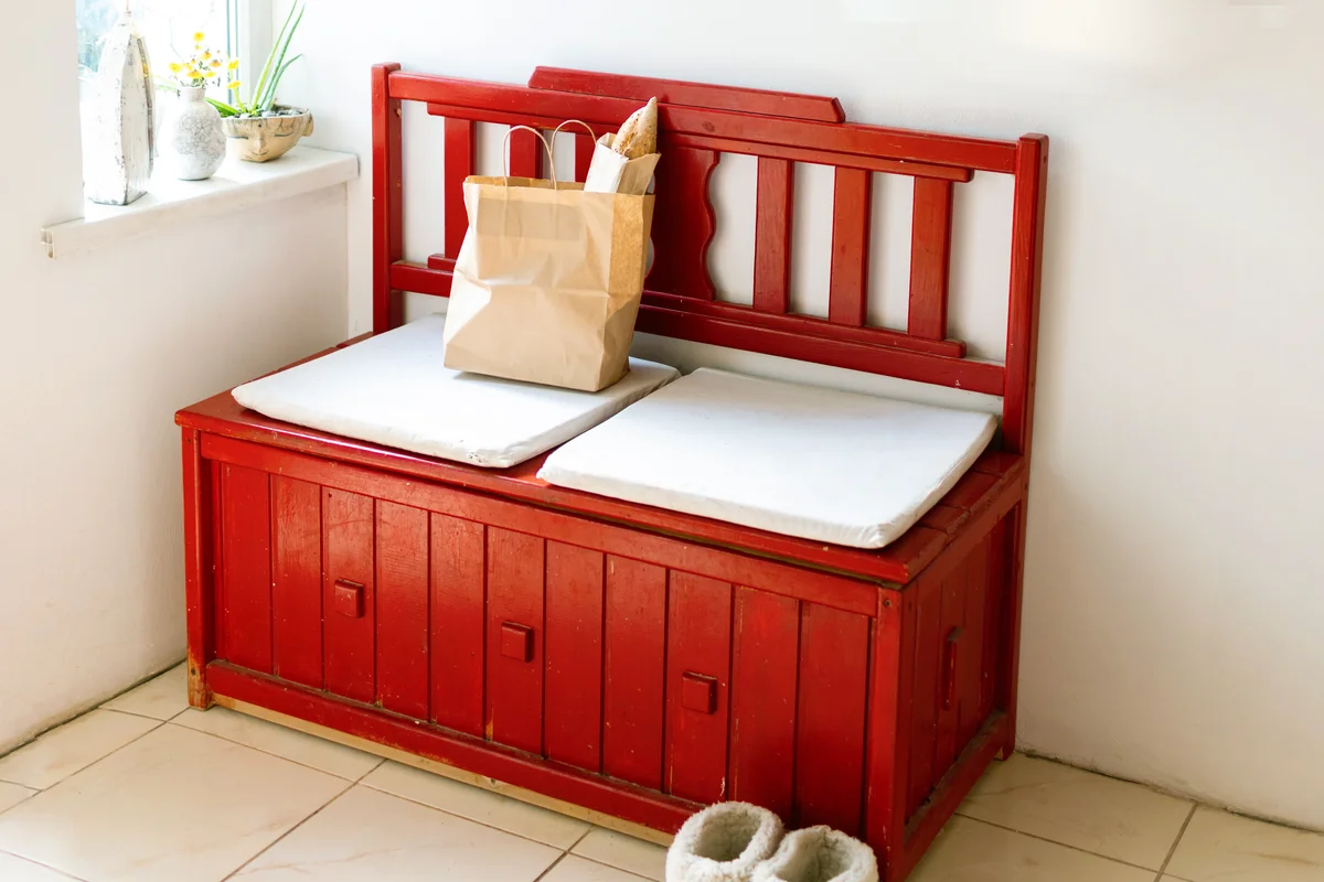 Red wooden bench in an alcove