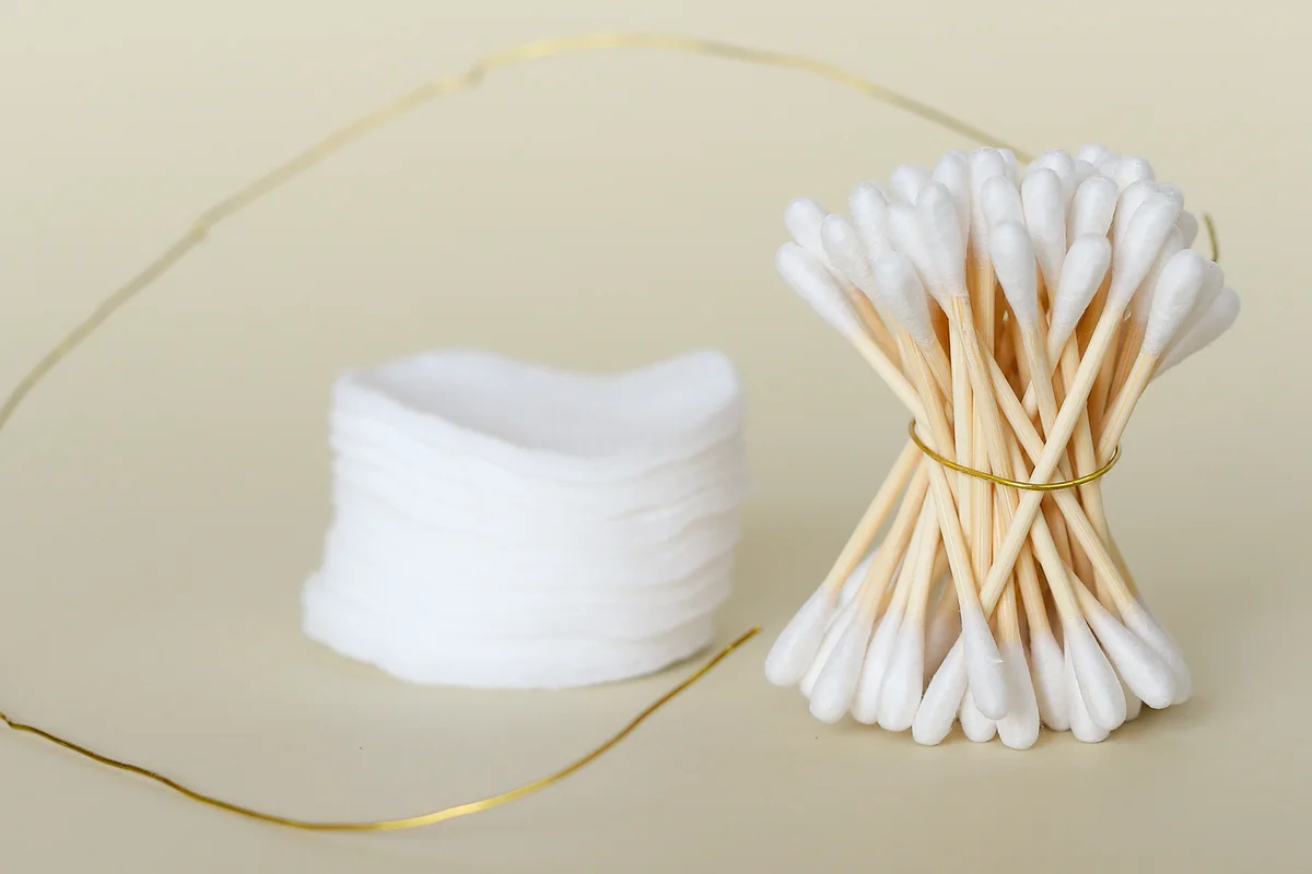 Ear Buds Tied Together With Golden String