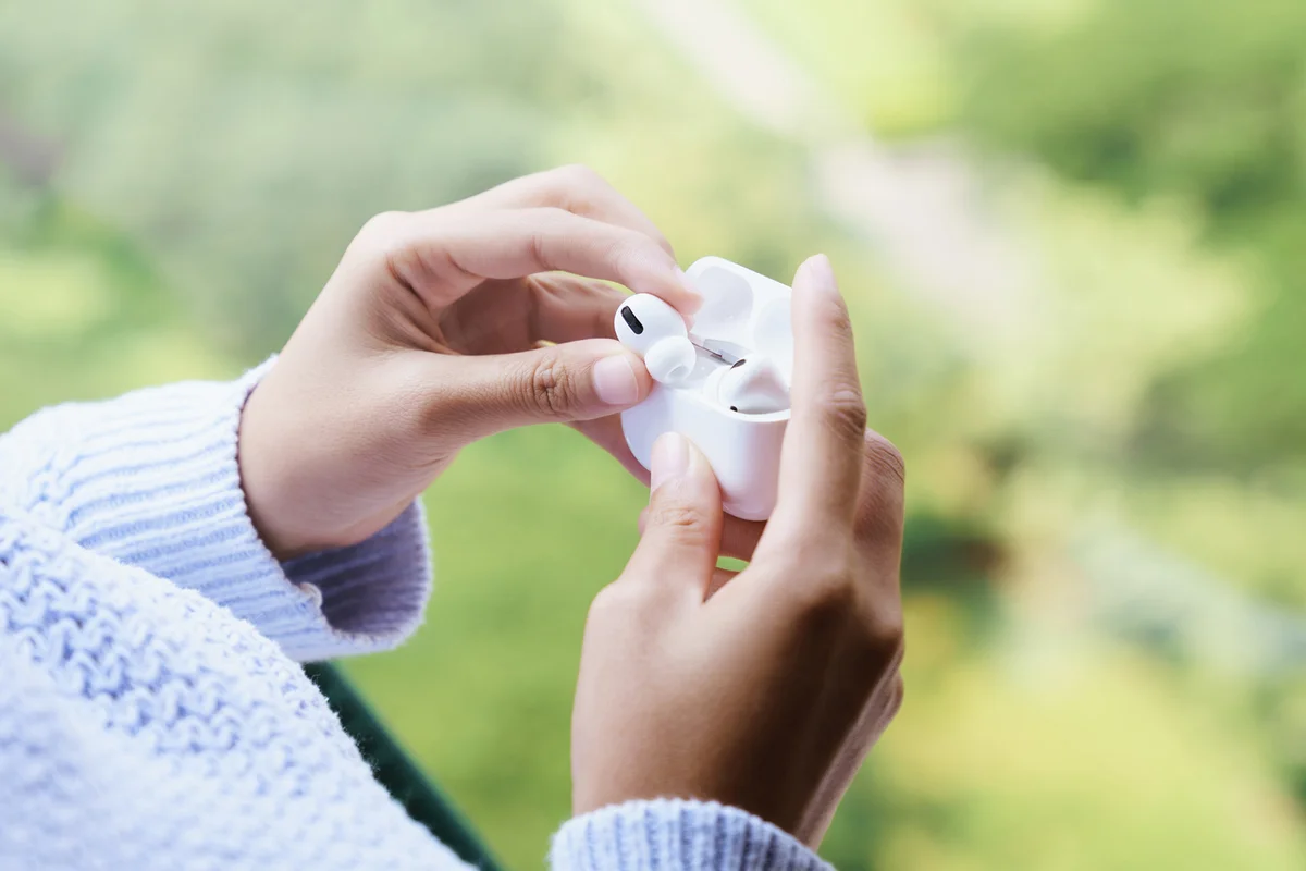 Earbuds headphone in female hand, new headphone technology