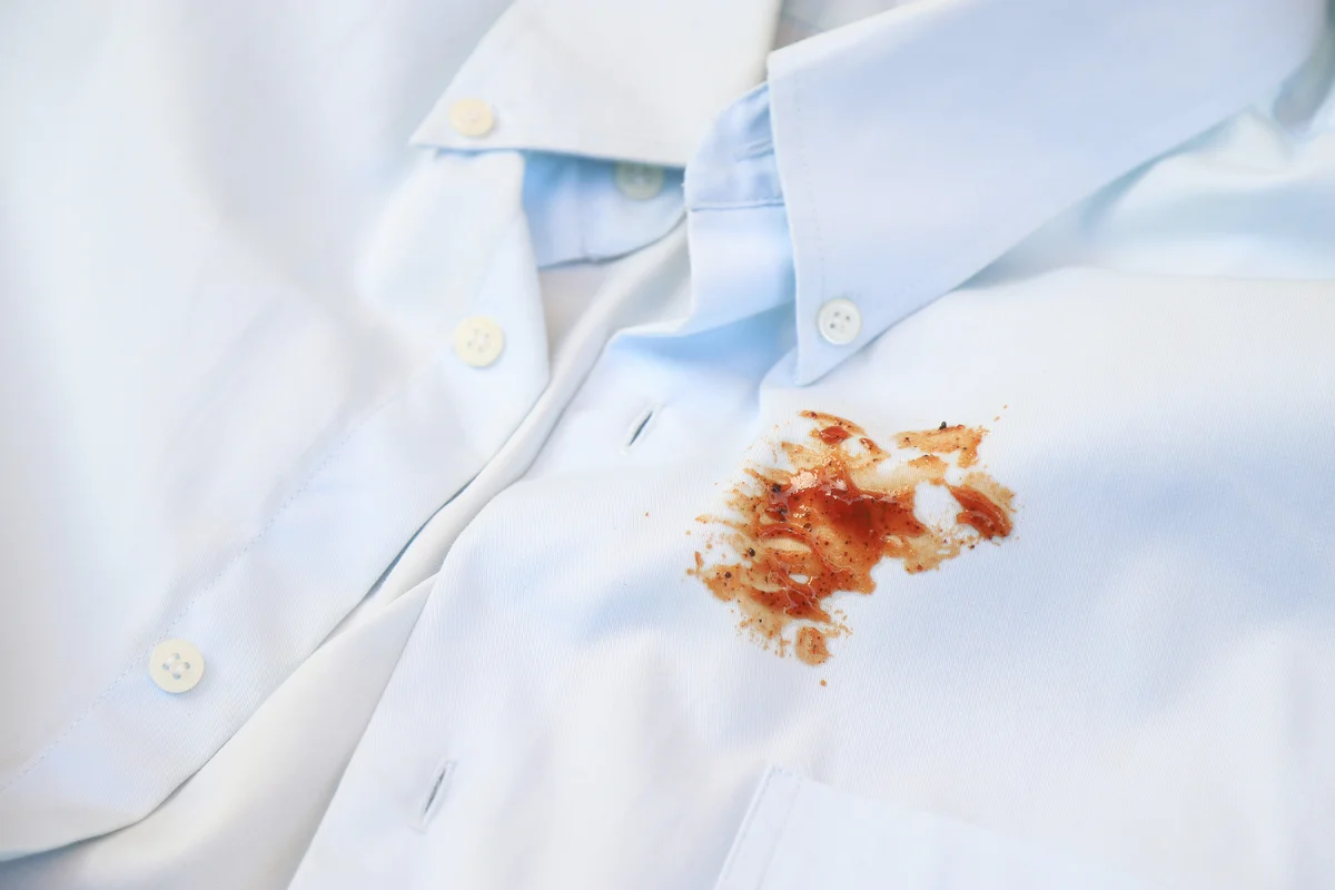 Dirty tomato sauce stain on white shirt