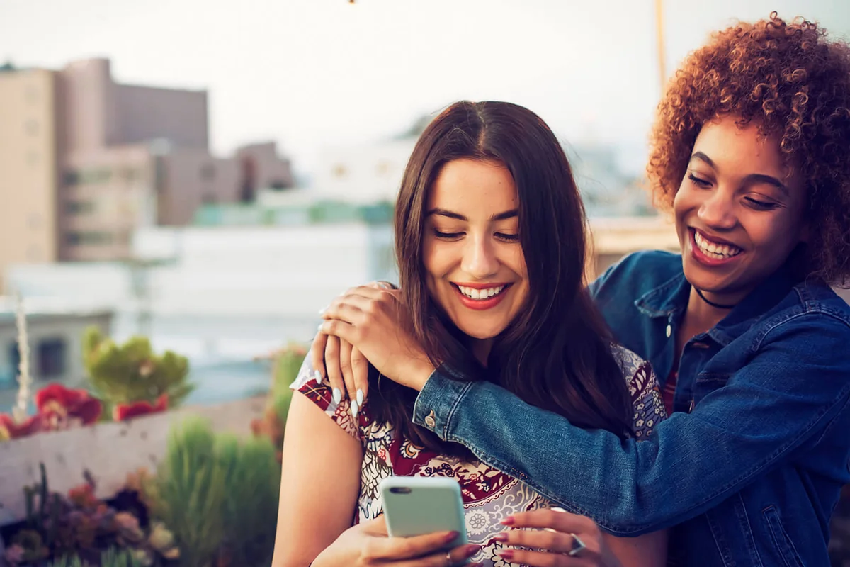 Friends taking a selfie on urban rooftop