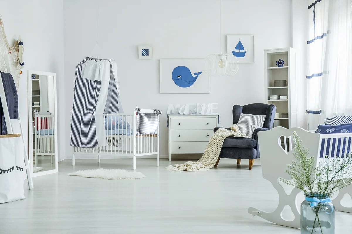 Spacious baby's room with crib ocean themed