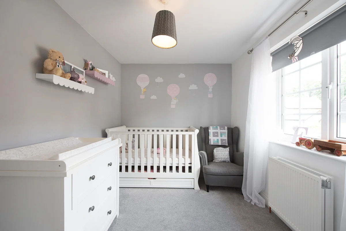 A general view of a child's nursery decorated with hot air balloons and clouds within a home