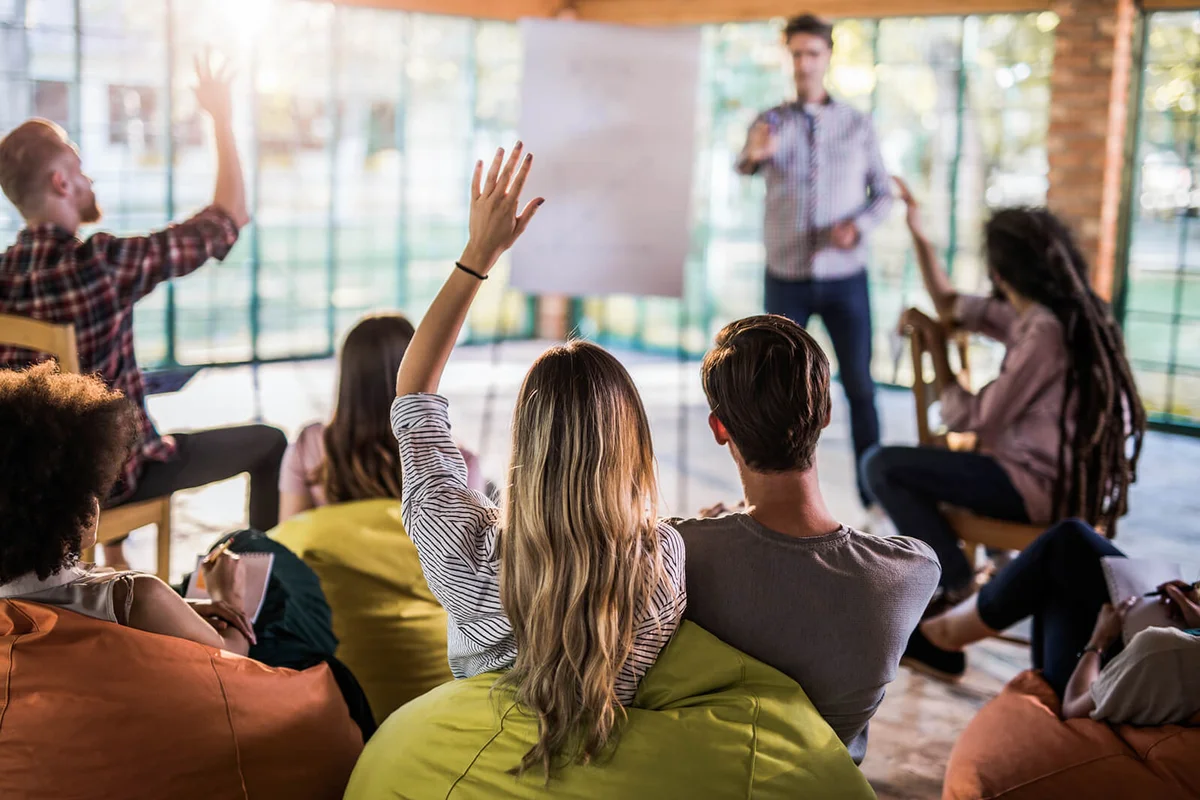 woman raising her arm while attending a training class