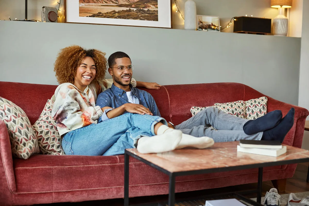 Young Couple Watching TV In Living Room