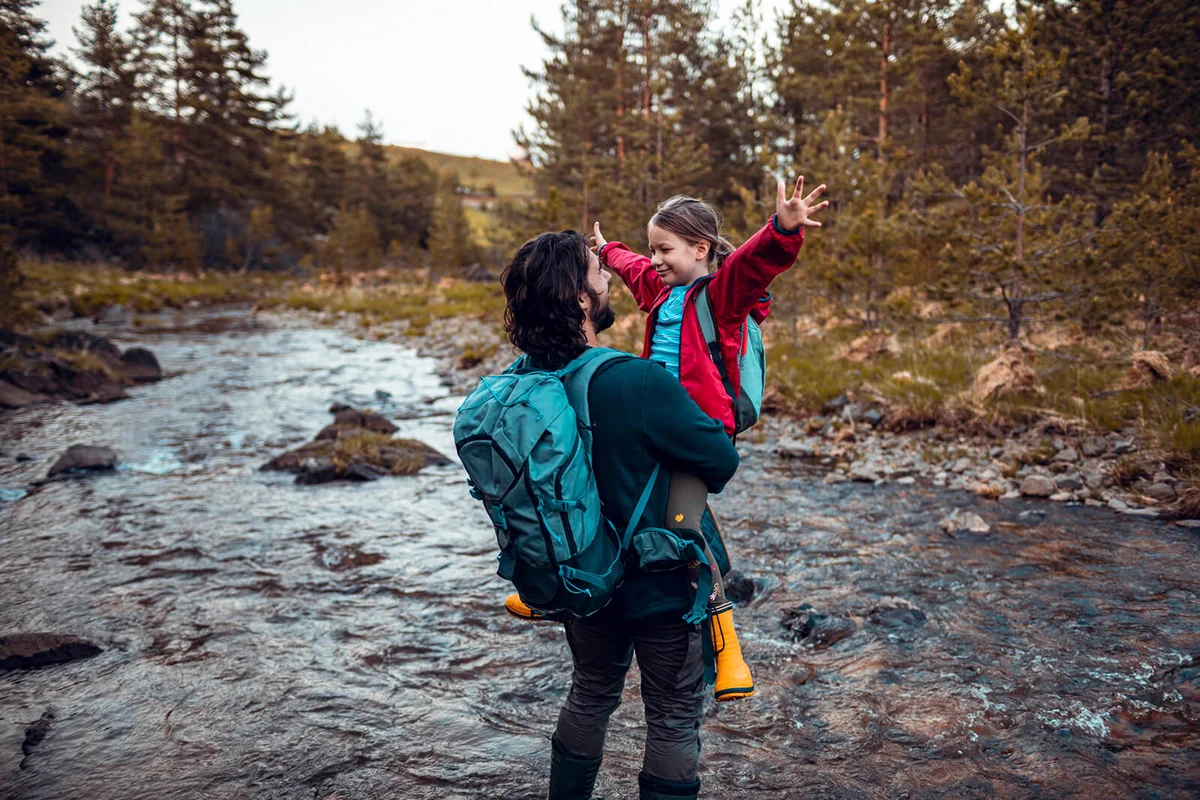 Father and Daughter crossing a stream