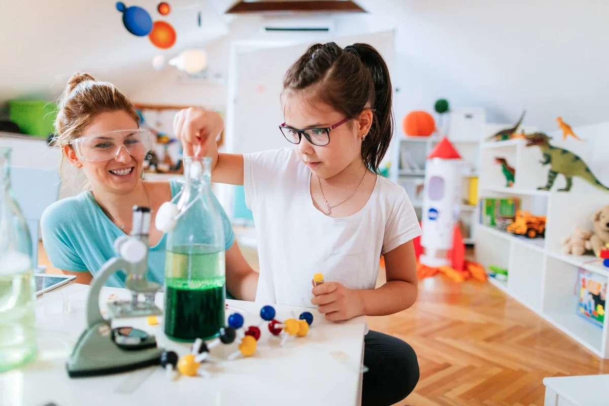 Girl and her mother doing scientific experiment