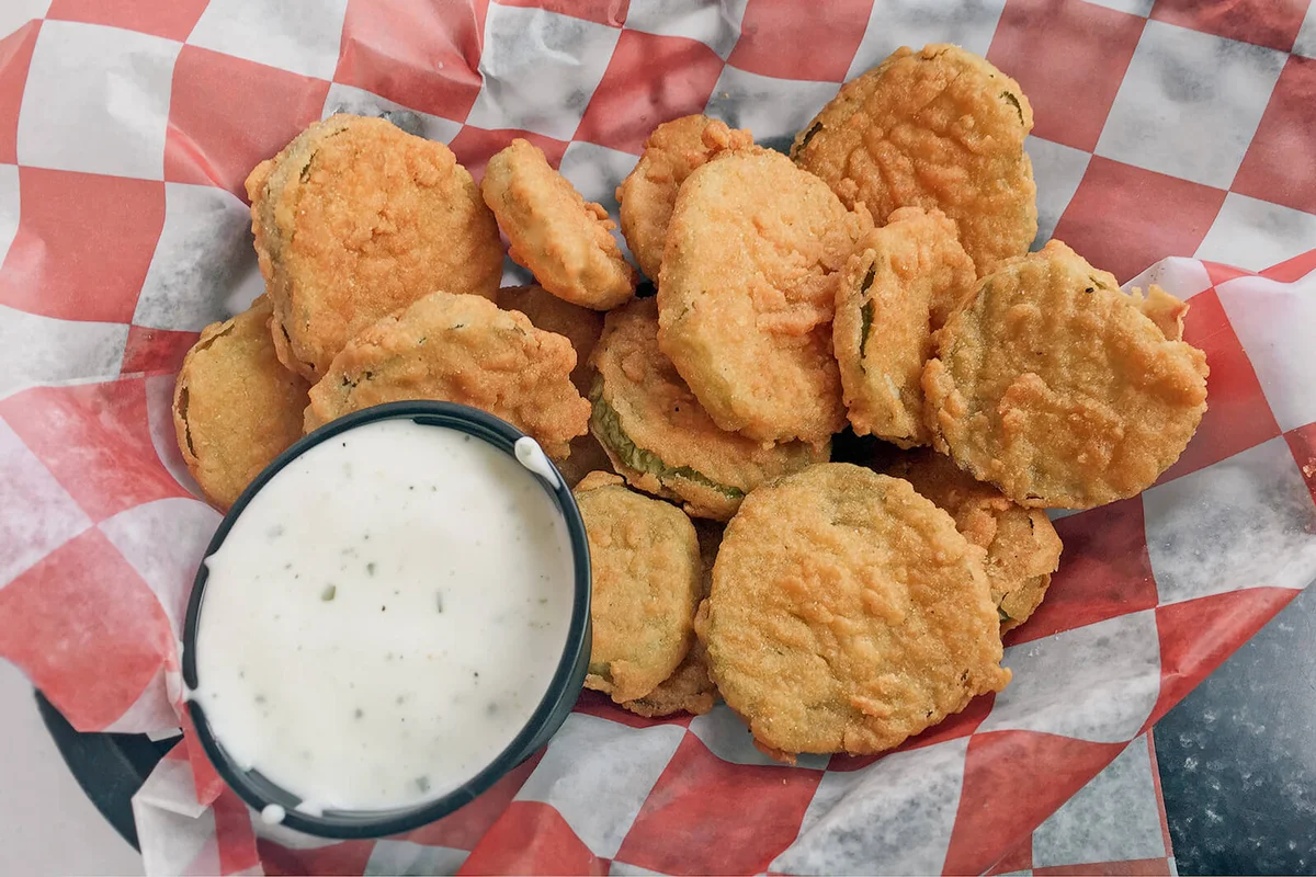 Fried pickles appetizer in a basket and ready to eat