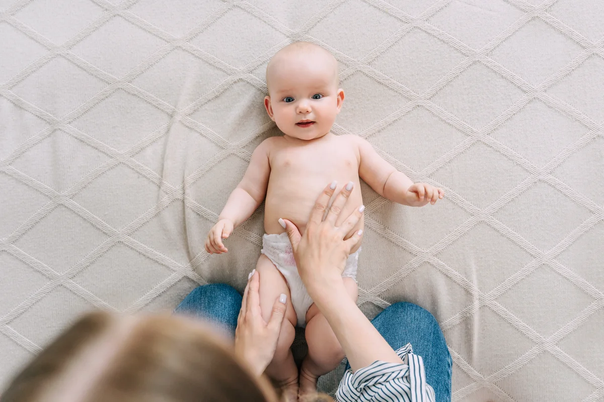Mom does gymnastics with a baby