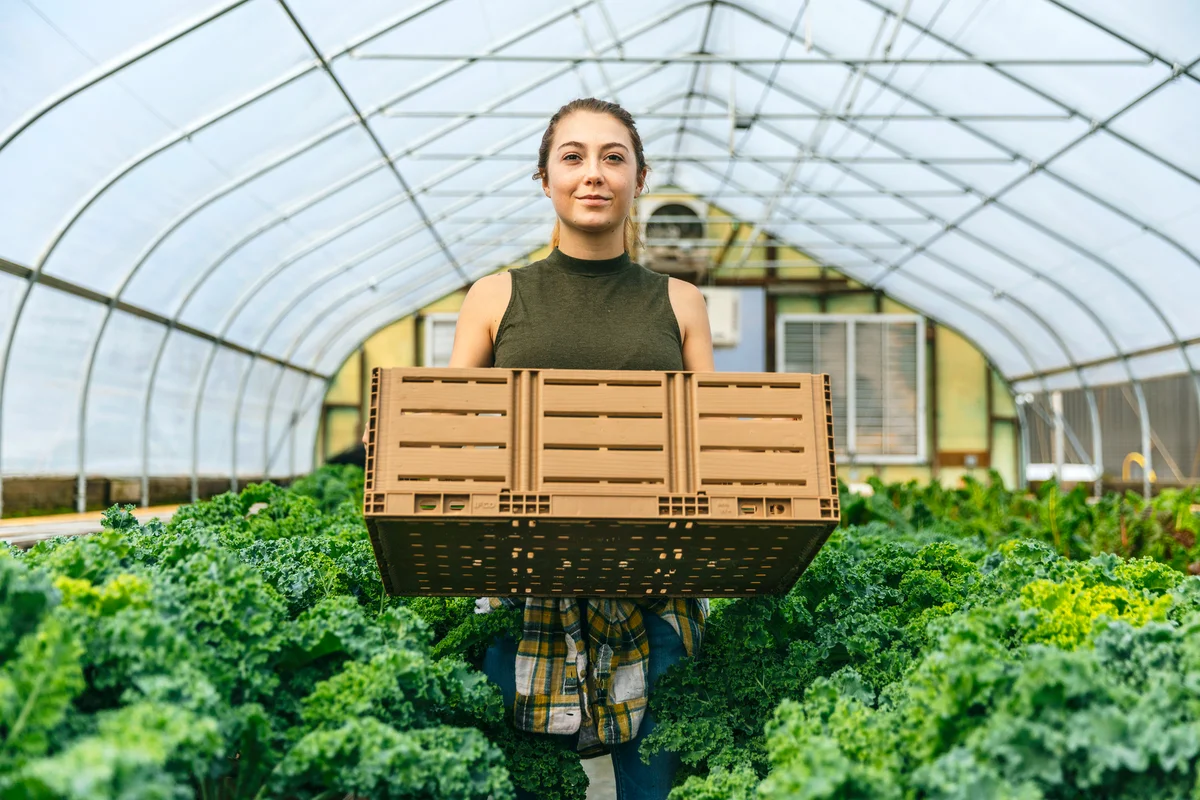 Woman farmer standing in greenhouse