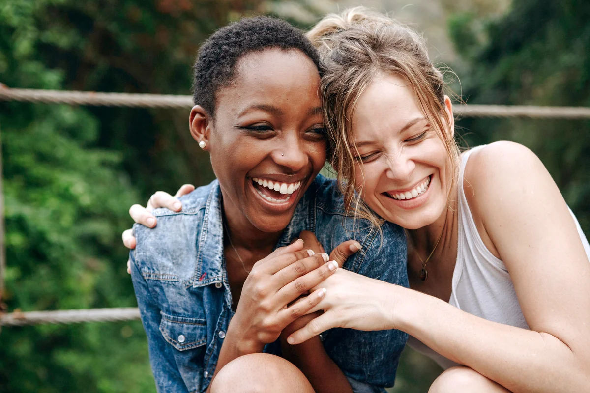 Happy friends holding each other