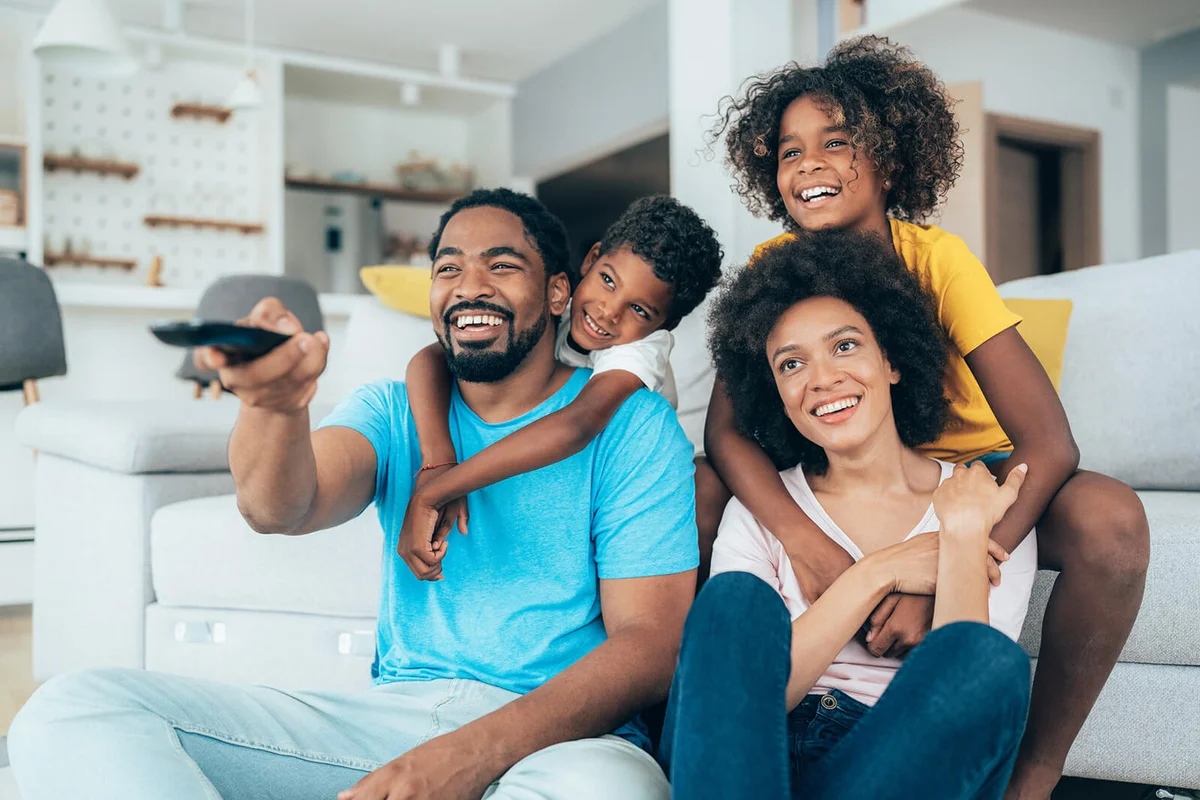 Family relaxing at home watching movies together