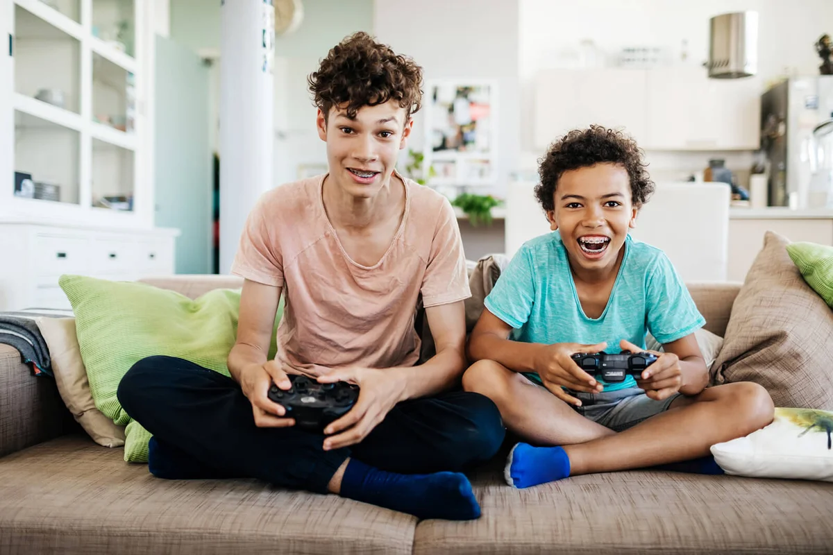 Two Brothers Having Fun Playing Computer Games Together