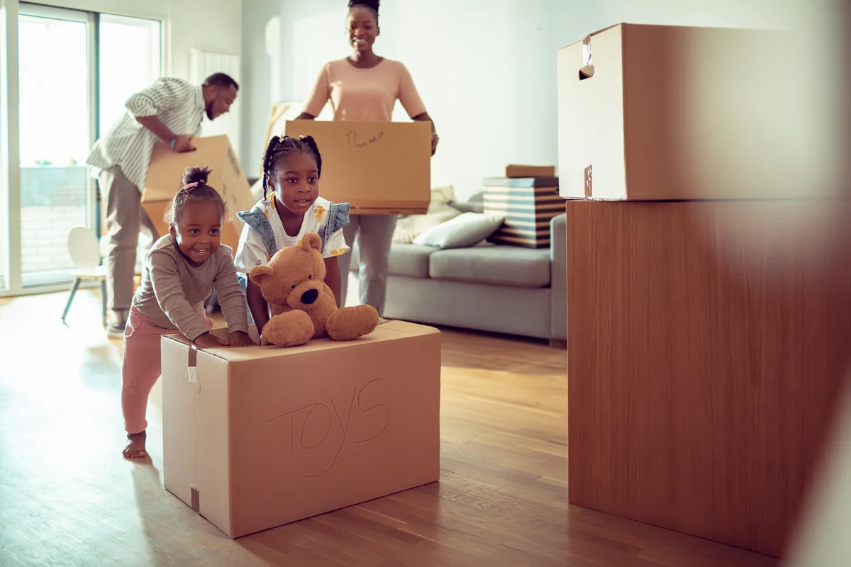Young family unpacking their things in their new home