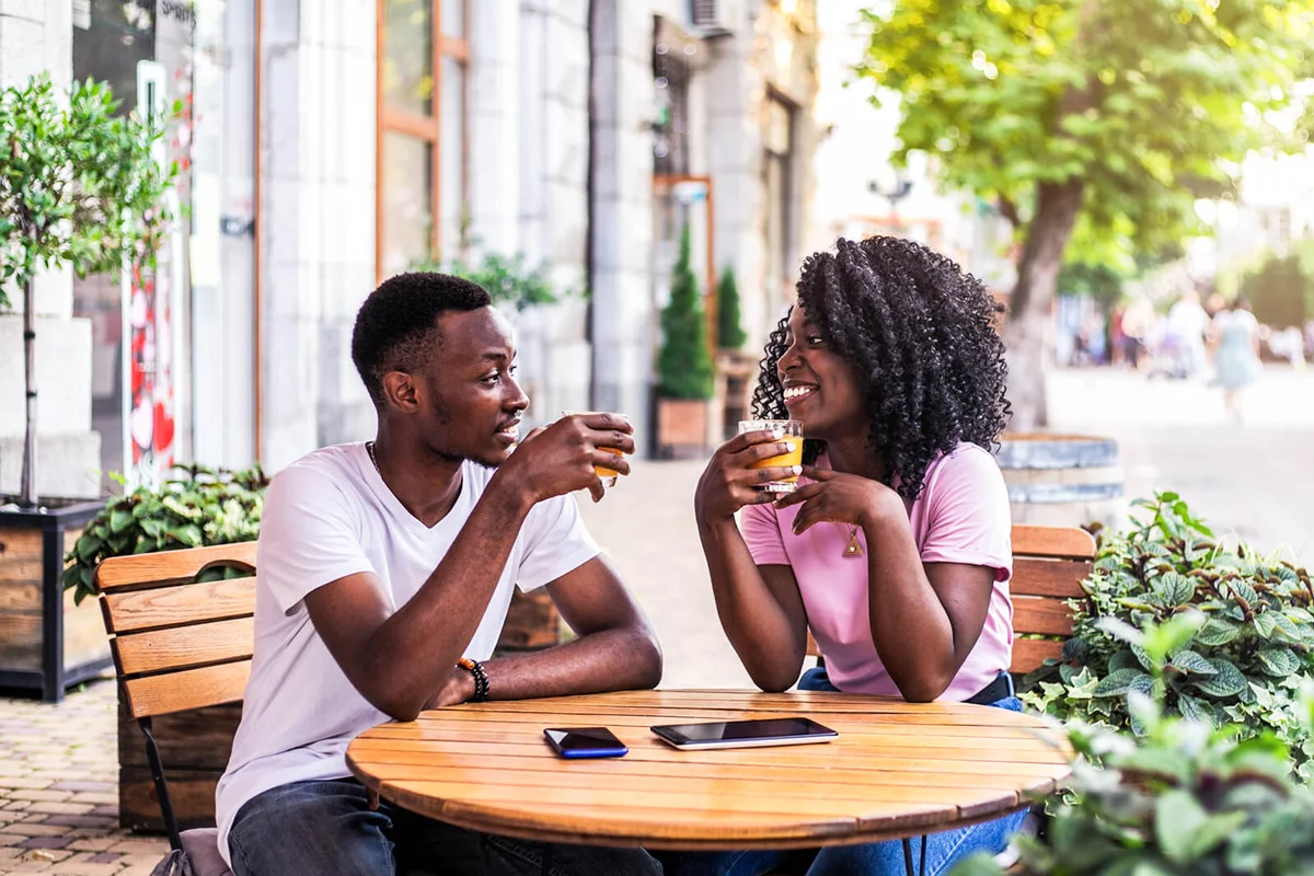 couple talking to each other at summer street cafe