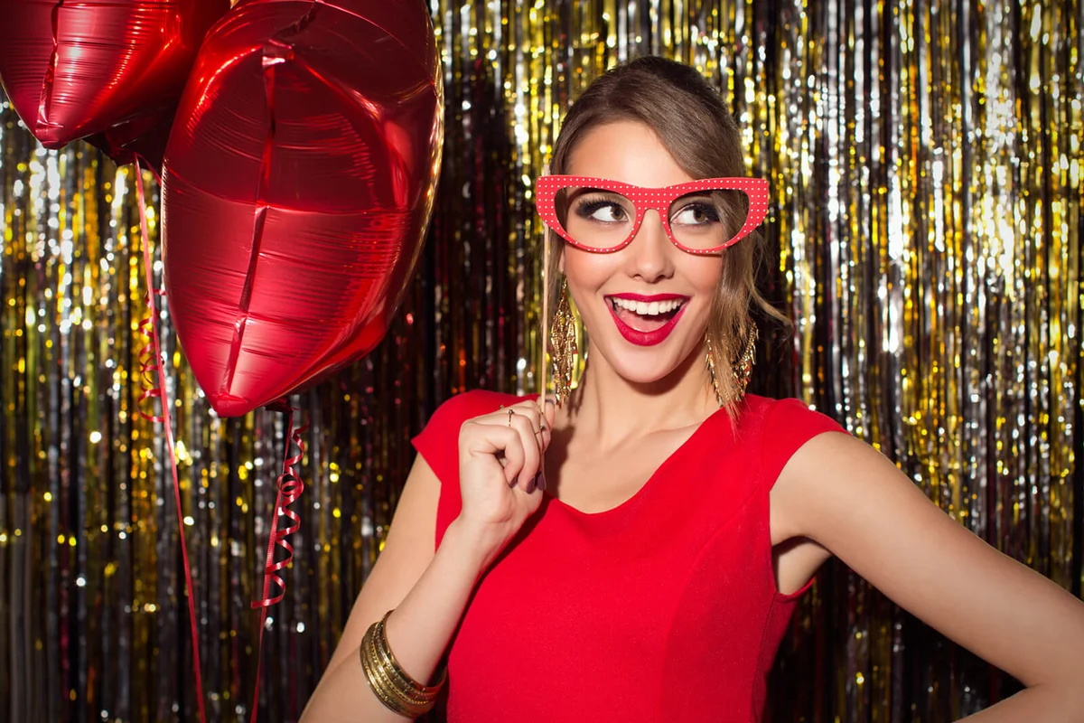 woman wearing elegant red dress celebrating or having party