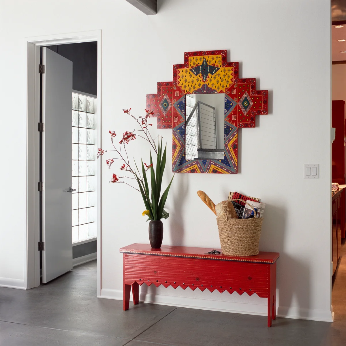 Upcycled red bench in a hallway with mirror