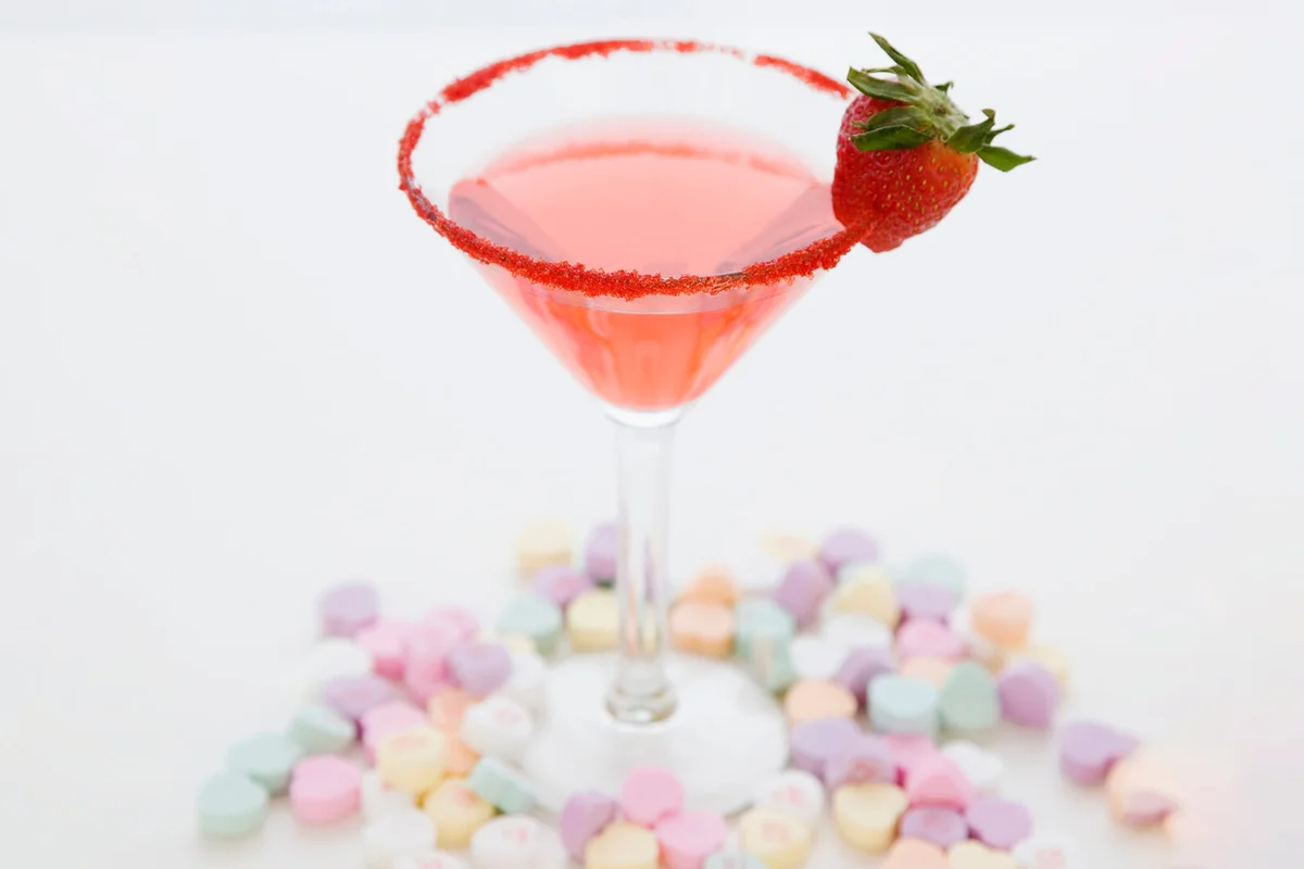 Cocktail surrounded by candy hearts