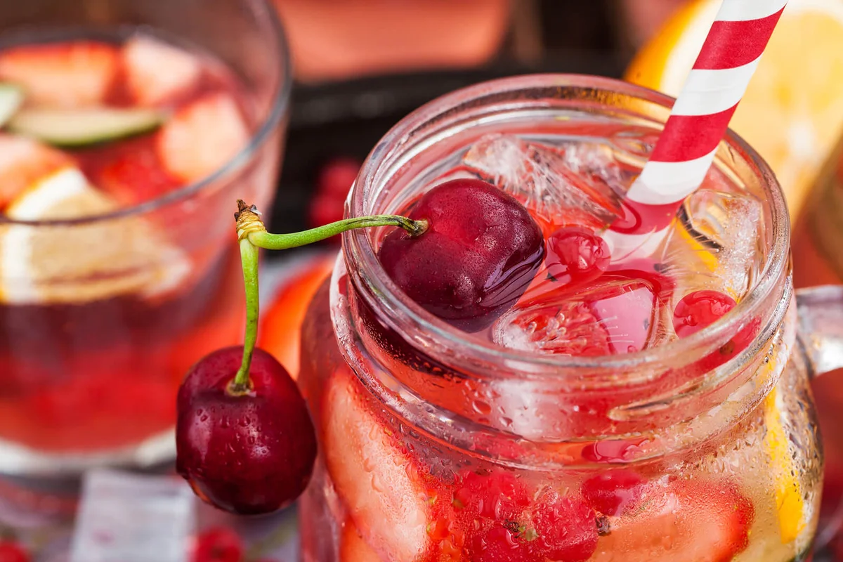 Mocktail with fresh berries and fruits in mason jar