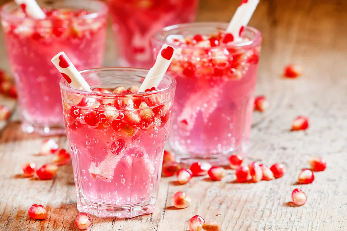 Pink cocktails for Valentine's Day with pomegranate seeds