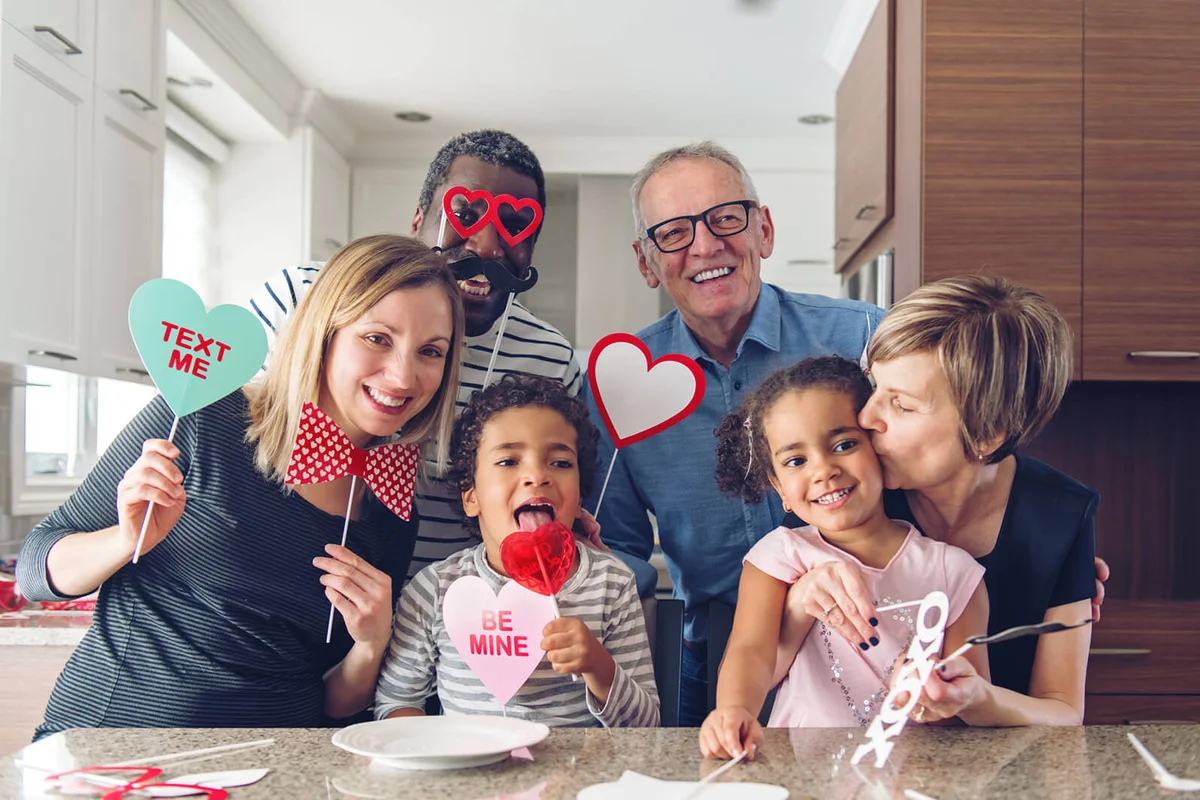 Mixed-race Family doing photobooth portraits on Valentine's Day