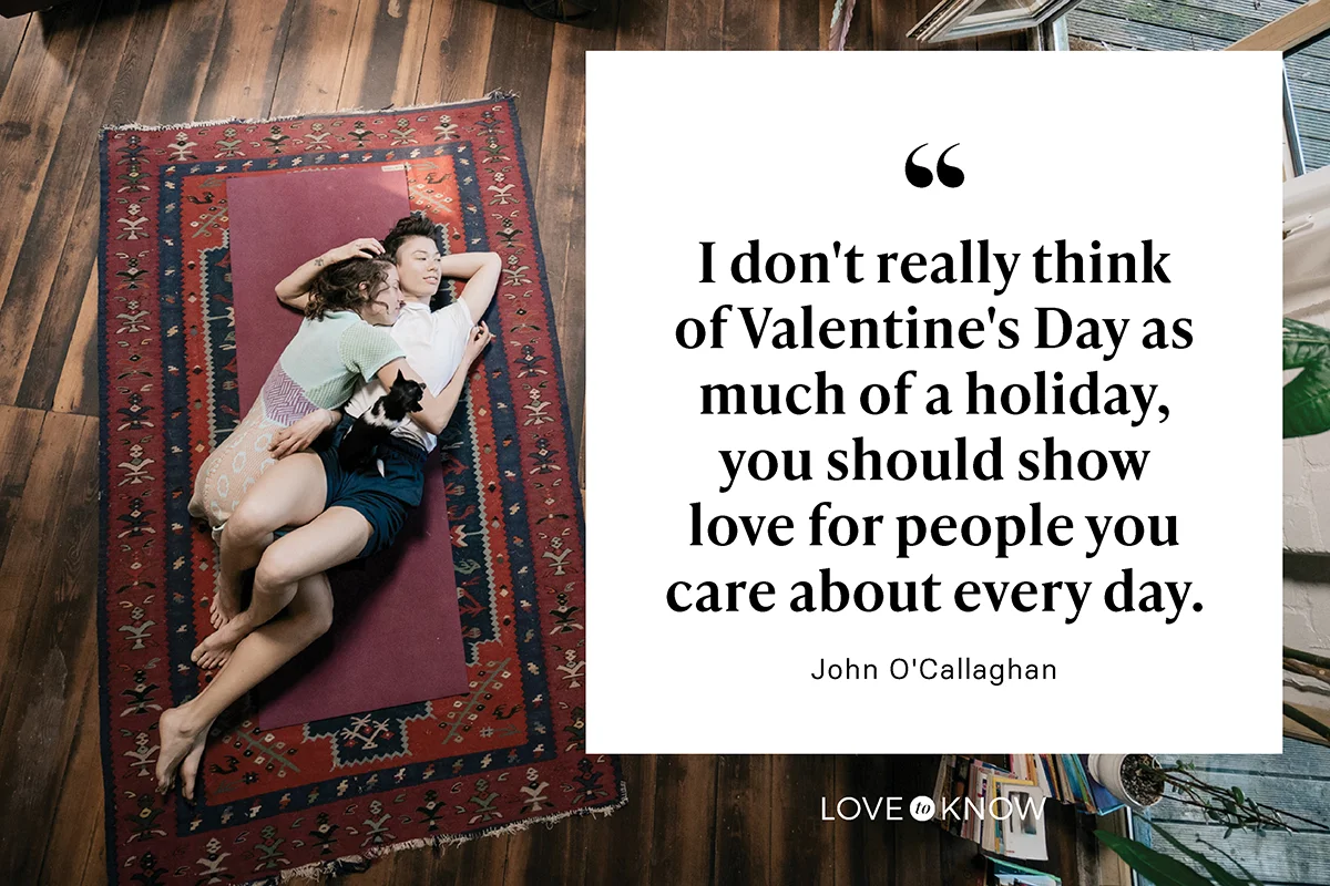 Couple Cuddling On Living Room Floor