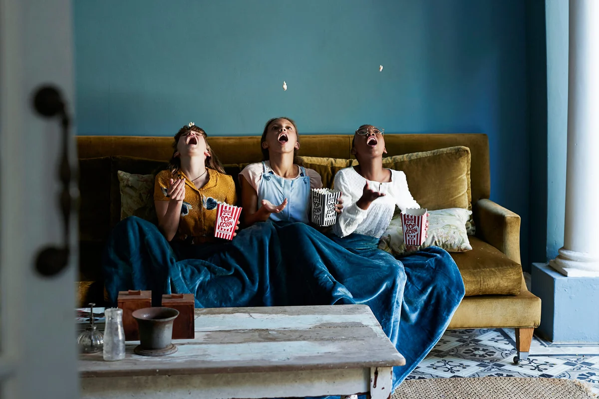 3 friends catching popcorn with the mouth