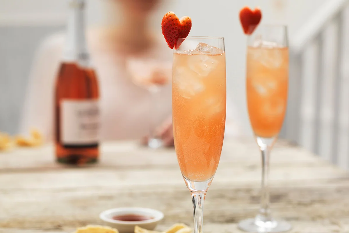 Champagne cocktails with hibiscus and strawberry hearts
