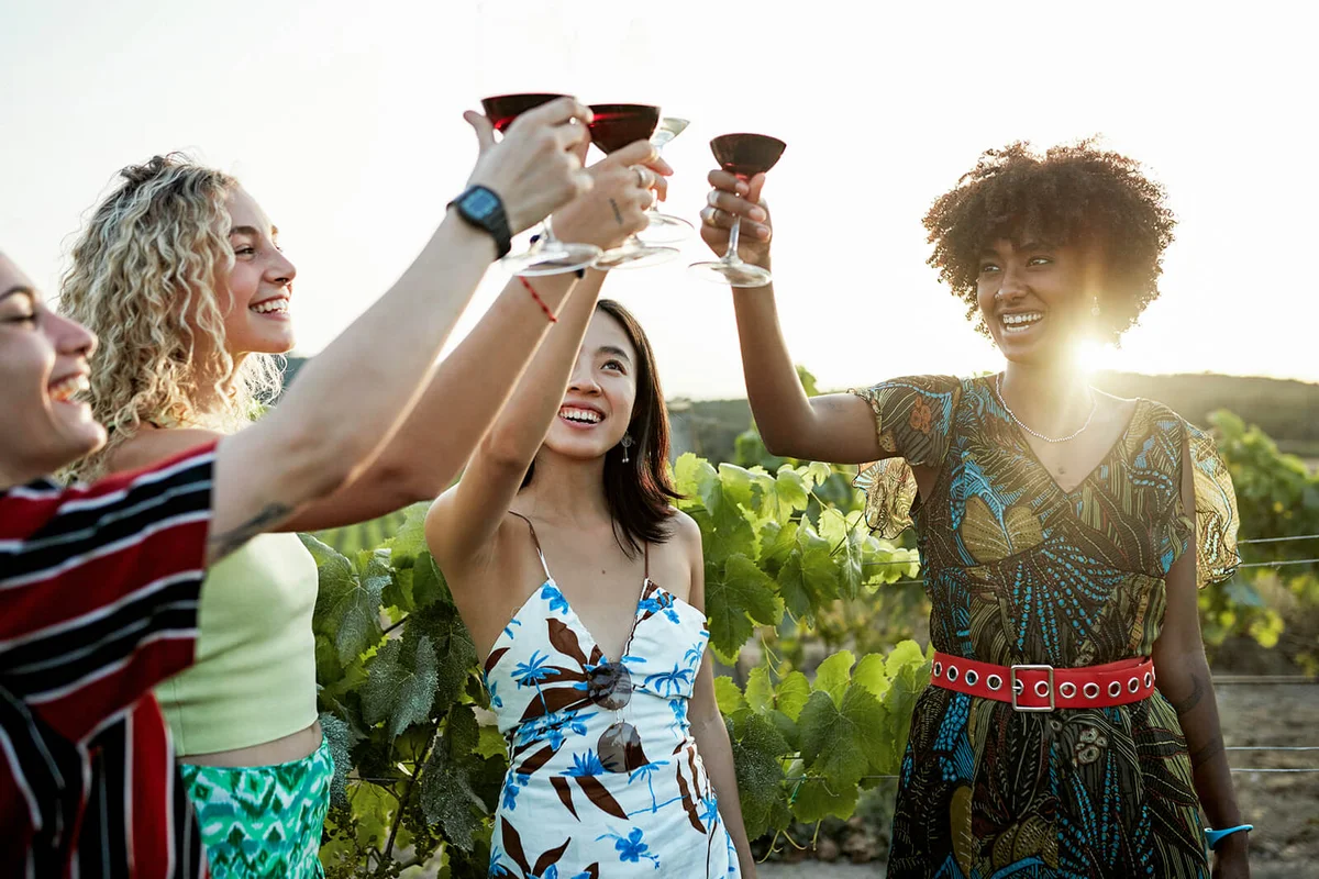 Smiling young women standing in vineyard