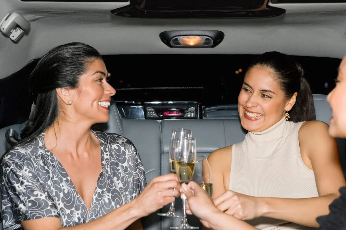 Women Drinking Champagne in a Limousine