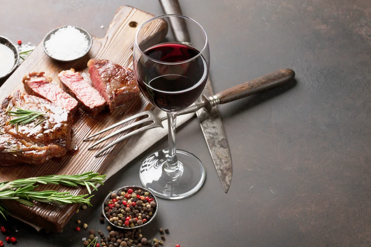Grilled ribeye beef steak with red wine
