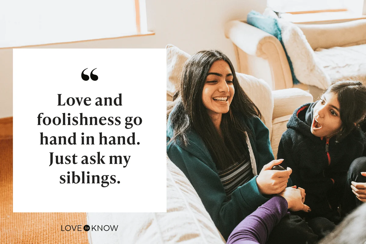 Two sisters sit on a sofa with their Mum