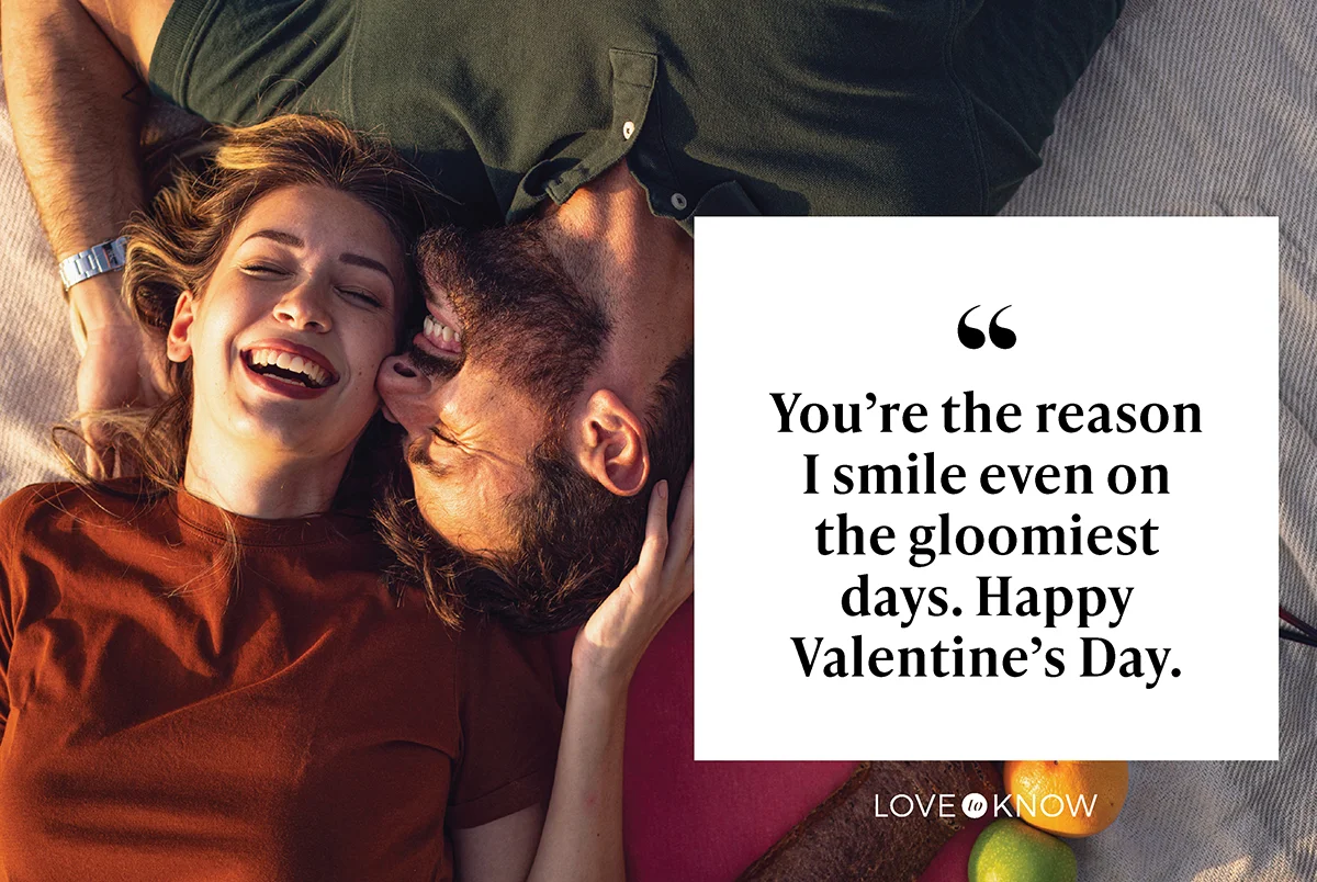 Happy young couple lying on the picnic blanket