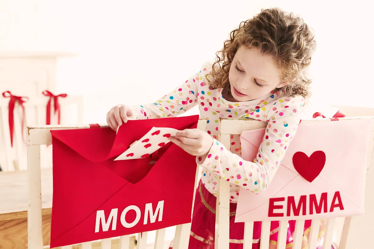 Girl Placing Valentine in Envelope