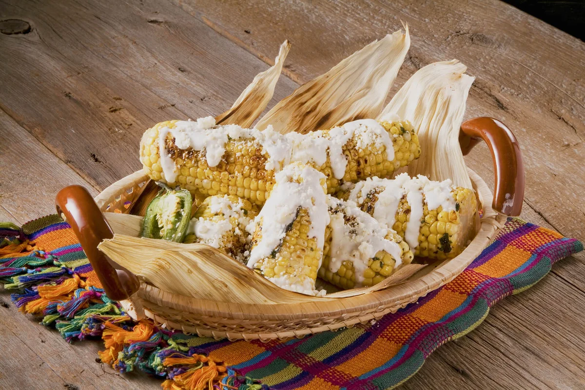 Grilled corn with crumbled cheese and cream