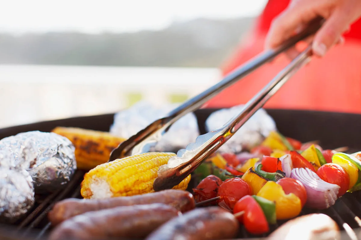 man grilling food on barbecue