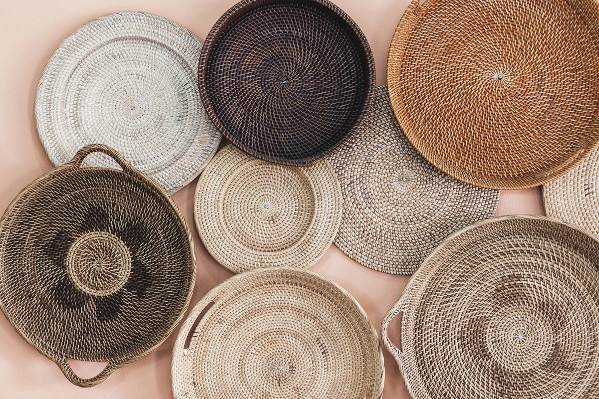 Wall decorated with different wicker handmade trays and baskets