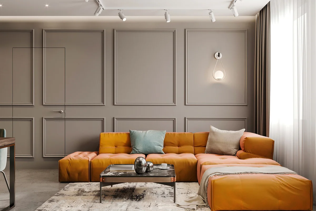Modern apartment living room interior with large sofa, in front of a blank wall with classic mouldings